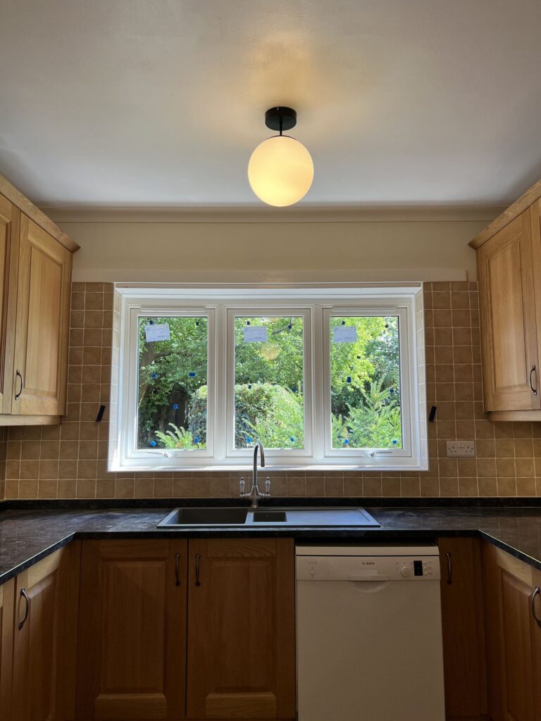 Cream uPVC flush casement kitchen window looking out over the garden