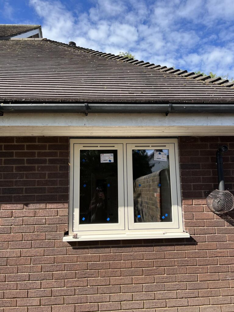 Close up of a newly installed cream uPVC flush casement window