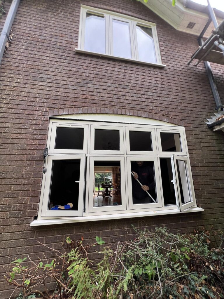 New cream uPVC flush casement window with curved head fitted to a red brick home in Newport, Shropshire