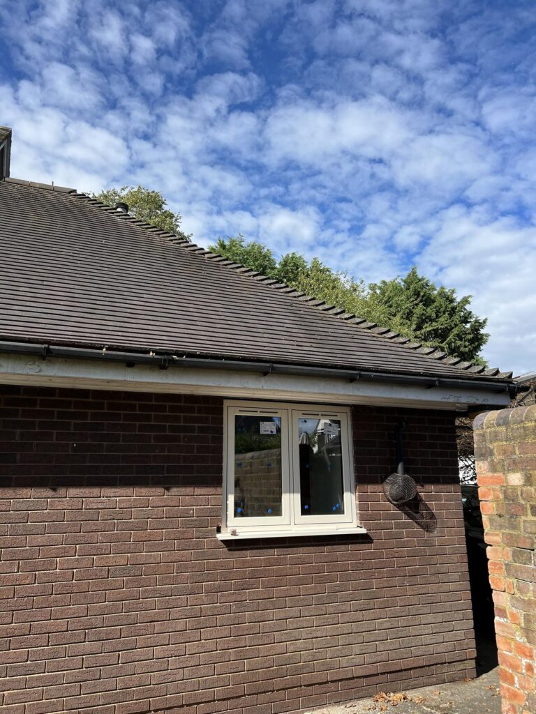 Cream uPVC flush casement window fitted to the single storey wing of a detached home