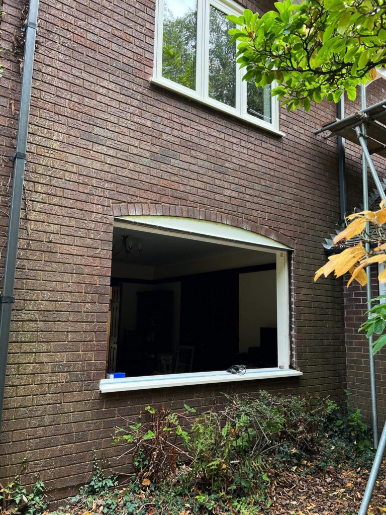 The wide rear opening cleared and ready for its replacement window